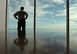 key man of a business looking out the window