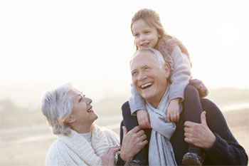 Seniors grandfather and grandmother walking with granddaughter